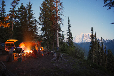 Camp fire on cliff by trees at North Cascades National Park - CAVF30058