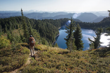 Rear view of man hiking on mountain - CAVF30115