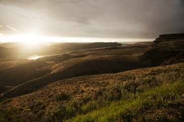 Scenic view of landscape against cloudy sky during sunset - CAVF30239