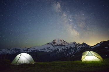 Illuminated tents on field against starry sky - CAVF30291