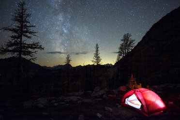 Illuminated tent on field against starry sky - CAVF30346