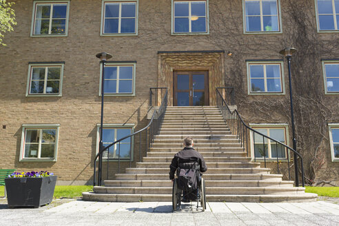 Mann im Rollstuhl vor einer hohen Treppe - FOLF02303