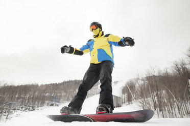 Low angle view of man snowboarding on field against clear sky - CAVF30509