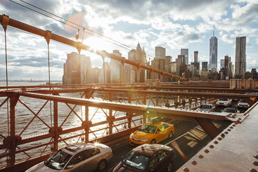 Vehicles on Brooklyn Bridge with city skyline in background - CAVF30574