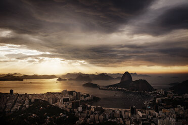 Scenic view of city and Guanabara Bay against cloudy sky during sunset - CAVF30609