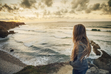 Side view of woman standing at beach during sunset - CAVF30683