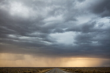 Idyllic view of stormy clouds raining over country road - CAVF30794