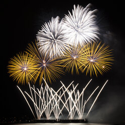 Low angle view of fireworks exploding against sky at night - CAVF30853