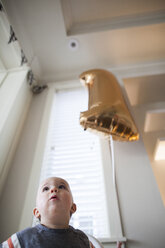 Babyjunge mit Heliumballon zu Hause - CAVF30858