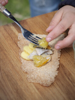 Putting pickled herring on crispbread - FOLF02803