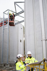 Four people working at water treatment plant - FOLF03234