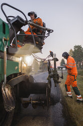 Two manual workers repairing road - FOLF03250