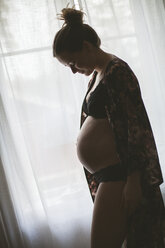 Schwangere Frau am Fenster stehend - FOLF03275