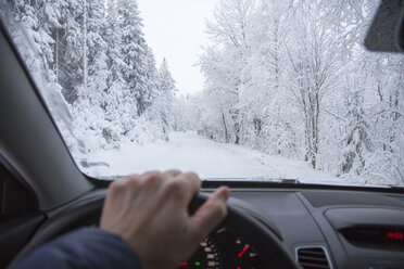 Close-up of man driving in forest in winter - FOLF03598
