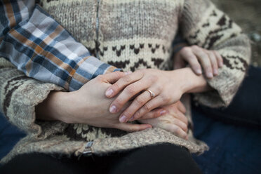 Cropped hand of boyfriend on girlfriend's stomach - CAVF30878