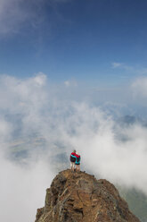 Hohe Winkel Ansicht von Freunden mit Armen um die Schultern stehen auf Cheam Peak gegen Himmel inmitten von Wolken - CAVF30912