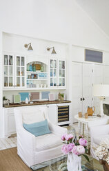 Sofa against cabinet in living room at beach cottage - CAVF30935