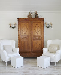 Armchairs and cupboard against wall in luxury cottage - CAVF30941