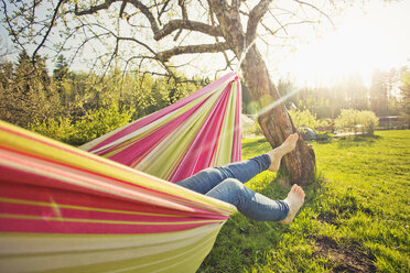 Low section of mid adult woman lying down on hammock - FOLF03615