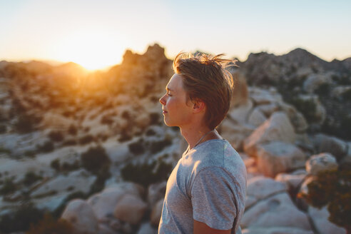 Young man contemplating at sunset in Joshua Tree National Park - FOLF03630
