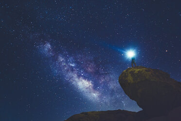 Man standing on rock in Joshua Tree National Park and looking at Milky Way - FOLF03632