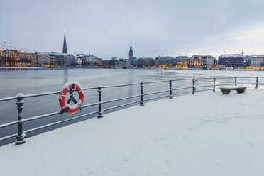 Germany, Hamburg, View to Jungfernstieg, frozen Inner Alster Lake in the evening - KEBF00784