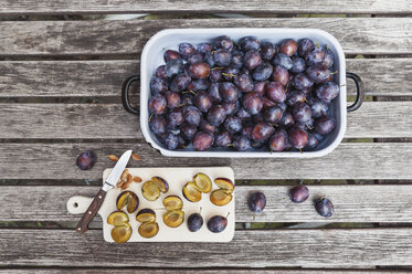 Fresh plums in casserole and chopped plums on chopping board - GWF05476