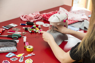 Close-up of girl using sewing machine - SARF03626