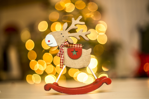 Wooden reindeer figurine, points of light stock photo