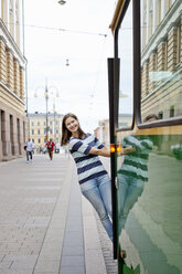 Young woman leaning out of tram - FOLF03936