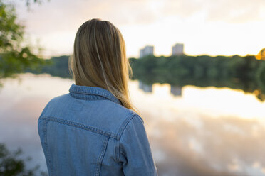 Teenage girl standing at edge of lake - FOLF03975