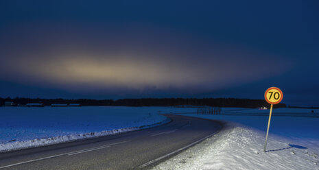 Speed limit sing by road in winter at dusk - FOLF04026