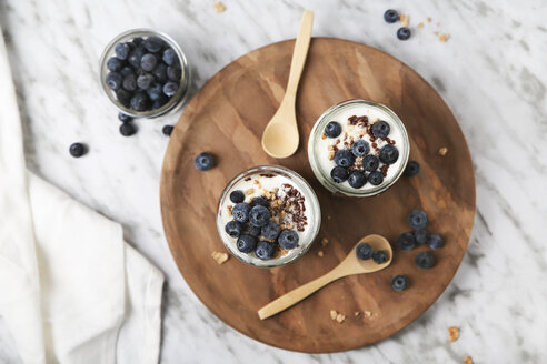 Chia pudding parfait with chocolate and yoghurt with blueberries and granola in jars - RTBF01113