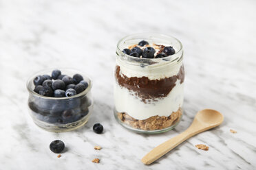 Jar of chia pudding parfait with chocolate and yoghurt with blueberries and granola - RTBF01117