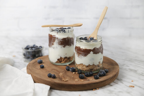 Chia pudding parfait with chocolate and yoghurt with blueberries and granola in jars - RTBF01120