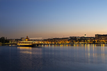 Waterfront view of illuminated city at dusk - FOLF04247