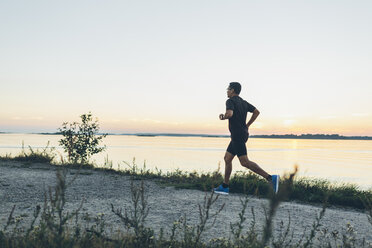 Mid adult man jogging at seashore - FOLF04293