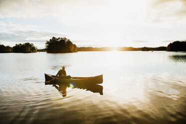 Man paddling canoe on lake - FOLF04336