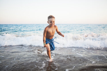 Young boy playing in the surf at a beach - FOLF04749