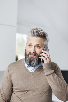 Mann im braunen Pullover telefoniert mit einem Handy - FOLF04765
