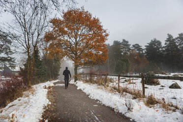 Man walking on a snowy trail - FOLF04792