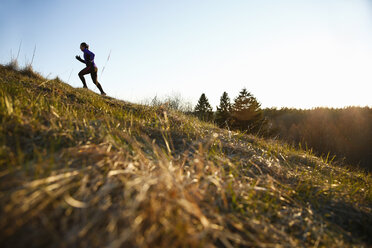 Woman running up a hill - FOLF04804