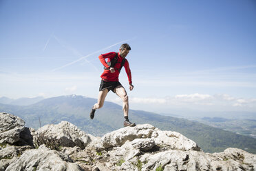 Man running on rocks in Annecy, France - FOLF04811