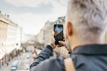 Man taking photograph of street in Stockholm, Sweden - FOLF04852