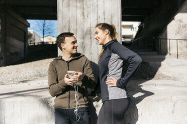 Couple laughing on street in Stockholm, Sweden - FOLF04912