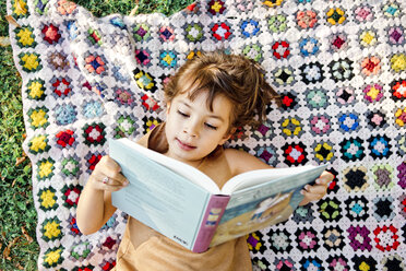 Girl reading on picnic blanket - FOLF05090