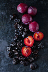 Fresh and dried plums on dark ground - CSF29043