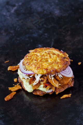 Veggie Burger made of potato fritters, sweet potatoes, soy meat, remoulade and Barbecue sauce stock photo