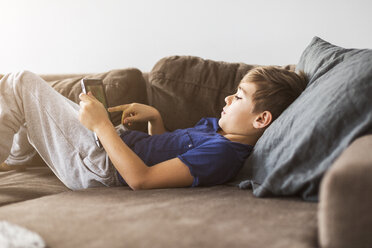 Junge auf Sofa spielt mit Tablet-PC - FOLF05208