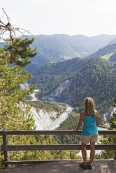 Switzerland, Grisons, woman looking to Rhine river and Ruinaulta - GWF05478